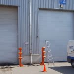 47267066 – seven yellow garage doors of a warehouse.